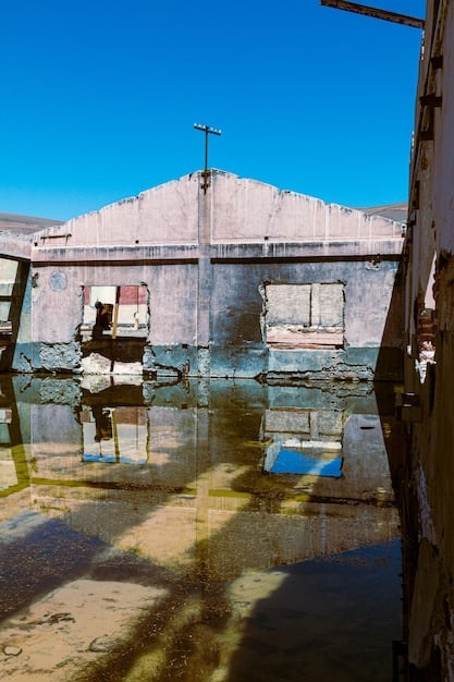 A flooded US military base after a severe storm, with damaged infrastructure and personnel struggling to navigate the high waters. Sandbags and emergency vehicles are visible, highlighting the vulnerability of the base to extreme weather events.
