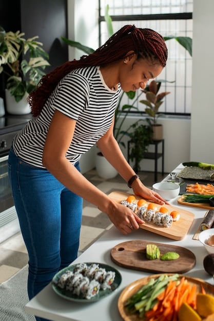 A photo depicting an American student learning how to prepare sushi in Japan with the help of a Japanese chef and student, showcasing hands-on cultural exchange and skill-sharing.