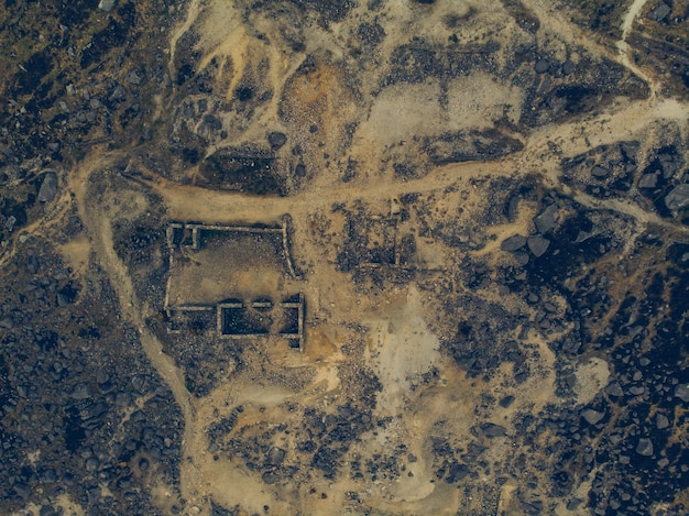 A satellite image showing a suspected nuclear facility in an undisclosed country. The facility is surrounded by a high-security perimeter and features several large industrial buildings and storage areas.